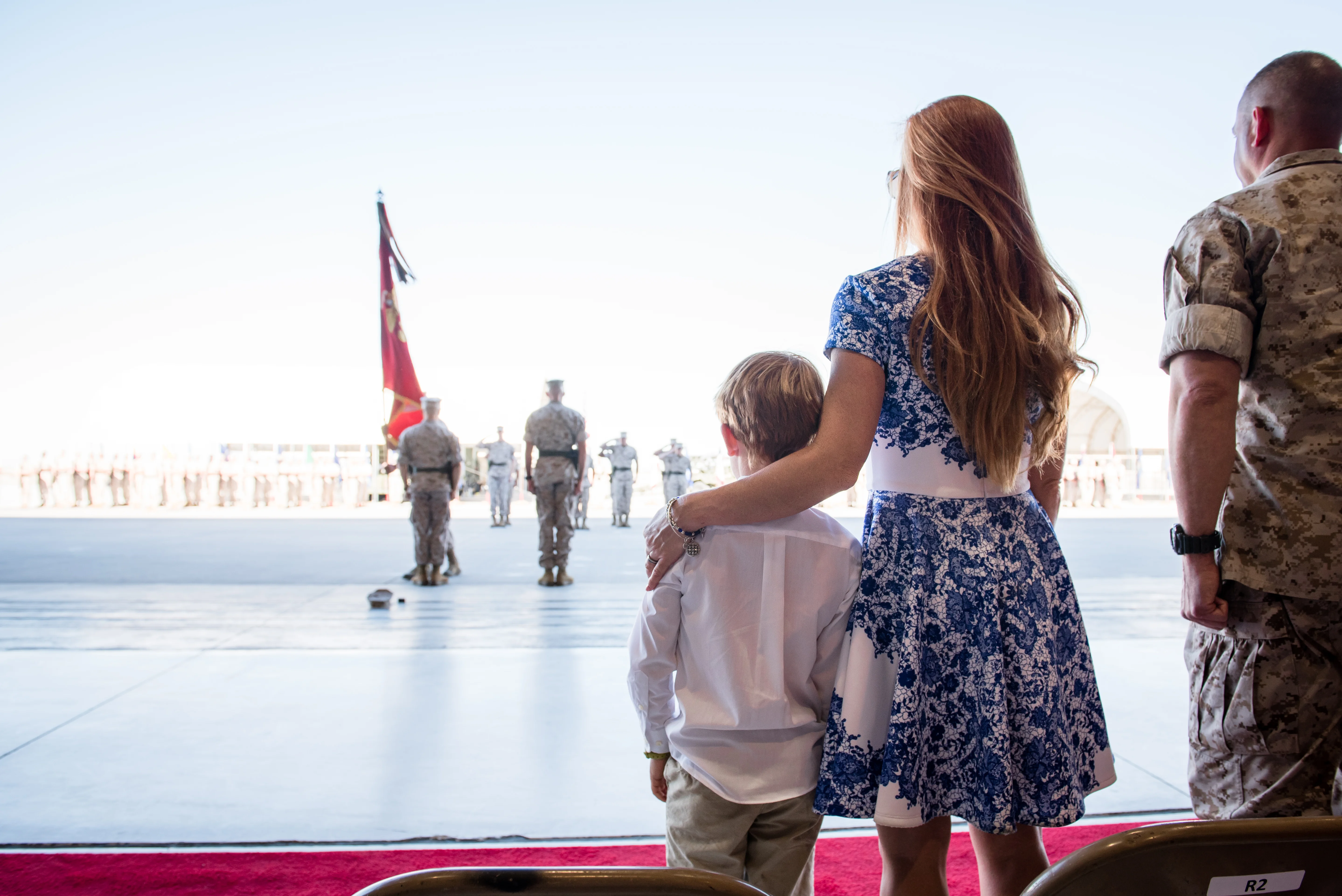 Military family standing near an american flag